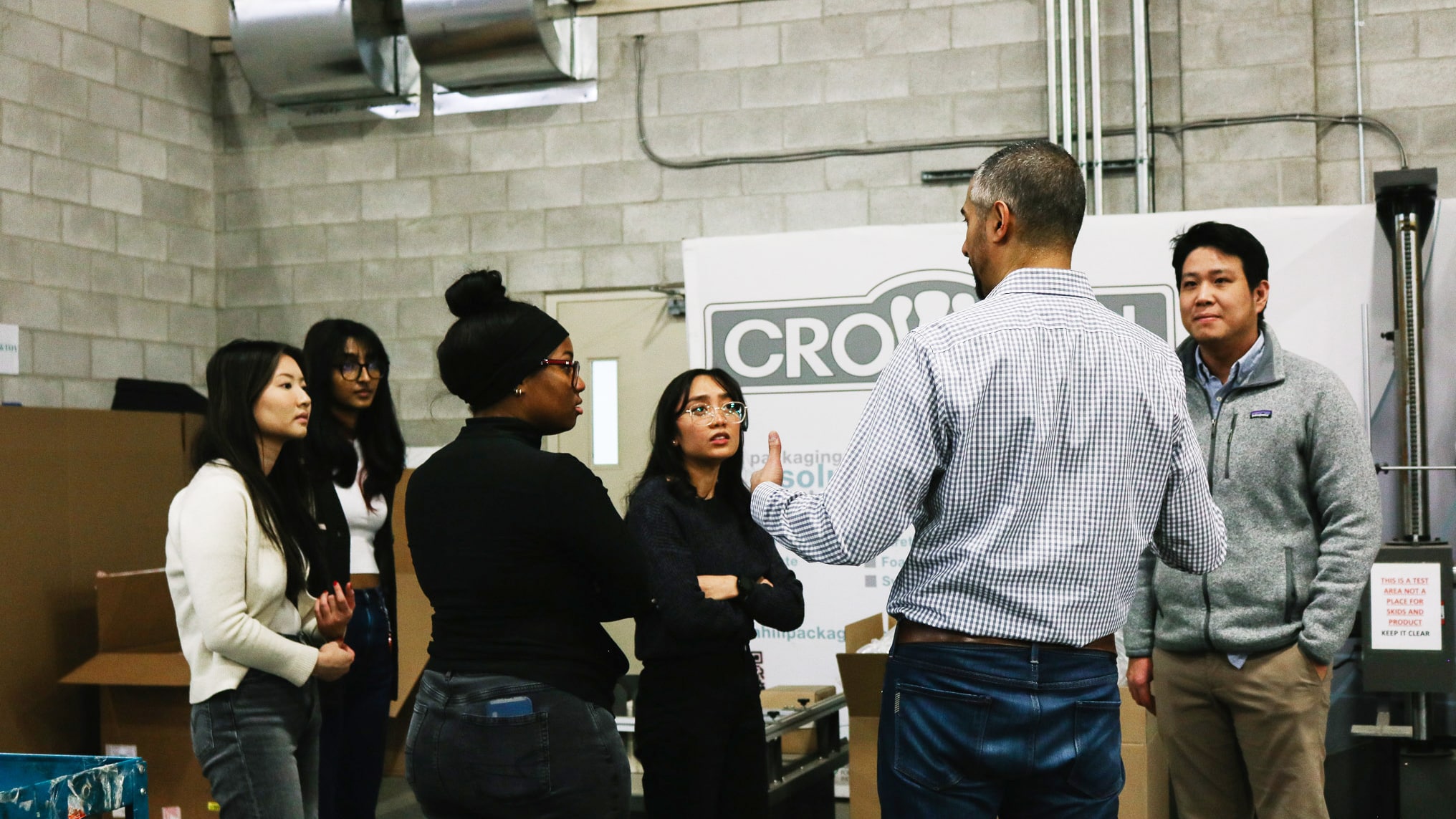 Students listening to Director of Strategy and Operations Marc Hyman during his guided tour of Crownhill's operations.