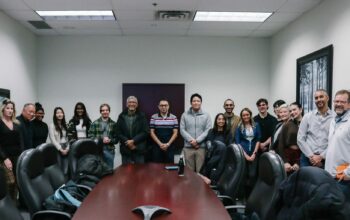 group picture of students and Crownhill packaging employees in the board room.